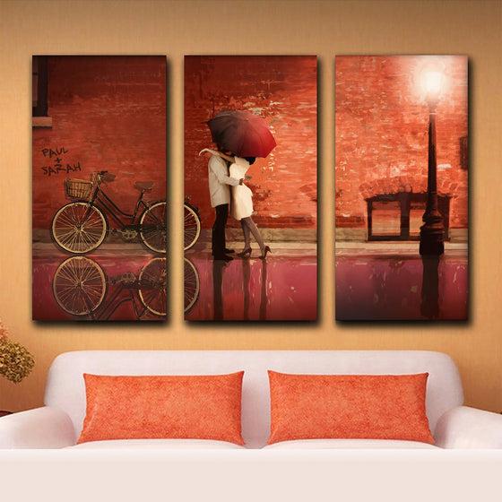 Three XXL canvas ast panels make up this personalized art with red brick wall and couple kissing - Personal-Prints